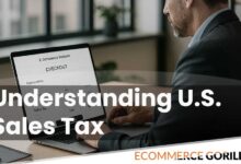 A business owner reviewing sales tax calculations for an online store on a laptop screen in a modern office.